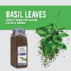 A jar of McCormick Culinary Basil Leaves with fresh basil leaves falling from the top.