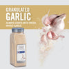 A jar of McCormick Culinary Granulated Garlic with fresh garlic cloves around it.