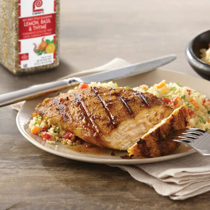 A plate of grilled chicken with lemon basil and thyme seasoning from Lawrys served over couscous.