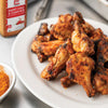 A plate of crispy golden brown chicken wings seasoned with Lawrys Smoky Chile &amp; Cumin Rub.