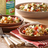 A bowl of Perfect Pinch Garlic &amp; Herb Seasoning chickpea salad with cucumbers tomatoes and red onions.