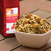 A bowl of Lawrys Mango Habanero Wings Seasoning Mix with a bottle of the seasoning in the background.