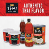 A collection of Thai Kitchen products including coconut milk green curry paste red curry paste sweet red chili and fish sauce.