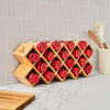A bamboo K-Cup holder displays red coffee pods on a kitchen counter.