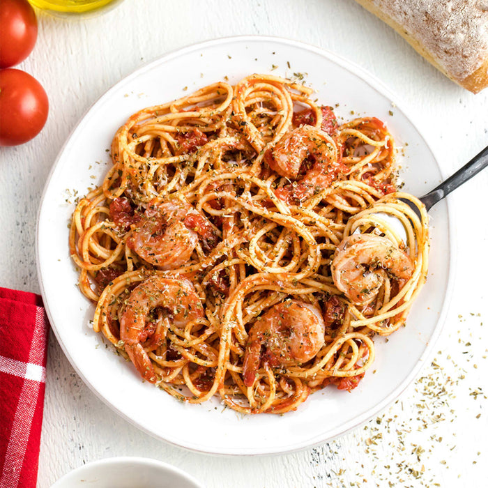 A plate of spaghetti with shrimp and tomato sauce is presented as a delicious and appetizing meal.