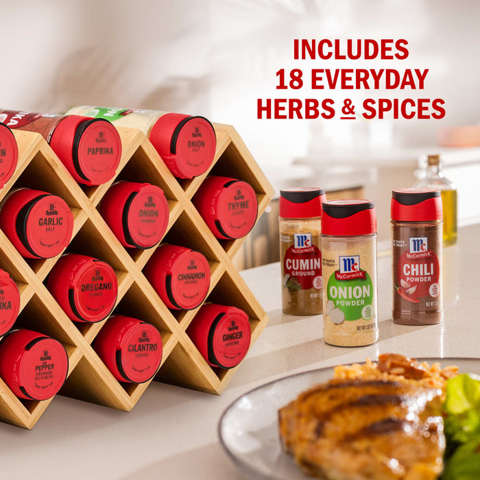 A McCormick spice rack with 18 everyday herbs and spices is displayed next to a plate of grilled chicken and rice.