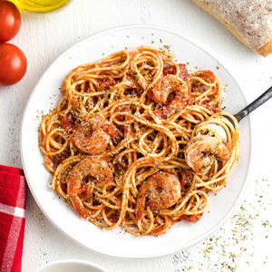 A plate of spaghetti with shrimp and tomato sauce, suggesting a delicious and satisfying meal.