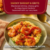 A plate of McCormick's Smoky Shrimp and Grits, featuring blackened shrimp, cheesy grits, and crispy bacon lardons.