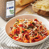 A bowl of pasta with tomato sauce parmesan cheese and marjoram leaves from McCormick Culinary.