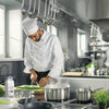 A chef in a white uniform is preparing a meal in a kitchen with a pot of boiling water on the stove and a bottle of McCormick Culinary Flavor Enhancer MSG.