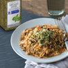 A plate of rice with beans and vegetables topped with McCormick Culinary oregano leaves.