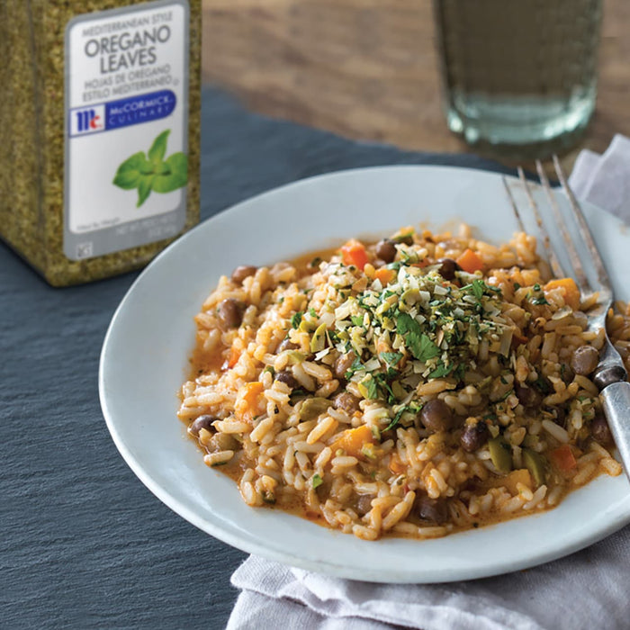 A plate of rice with beans and vegetables topped with McCormick Culinary oregano leaves.