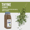 A bottle of McCormick Culinary Thyme Leaves with fresh thyme sprigs falling from the top.