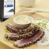 Sliced tuna with sesame seeds and a side of white noodles and a small bowl of mayonnaise.