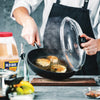 A chef is cooking crab cakes in a pan with Old Bay seasoning.