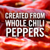 Red chili peppers are piled high, with the text CREATED FROM WHOLE CHILI PEPPERS superimposed on top.