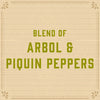 A woodgrain background with the text BLEND OF ARBOL &amp; PIQUIN PEPPERS in green.