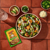 A bowl of shrimp salad with a packet of Cholula Jalapeno Lime seasoning mix.