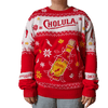 A person wears a festive red and white holiday sweater featuring the Cholula logo and a large illustration of a hot sauce bottle wrapped in lights.