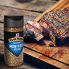 A bottle of McCormick Grill Mates Montreal Steak seasoning sits next to a sliced steak on a wooden cutting board.