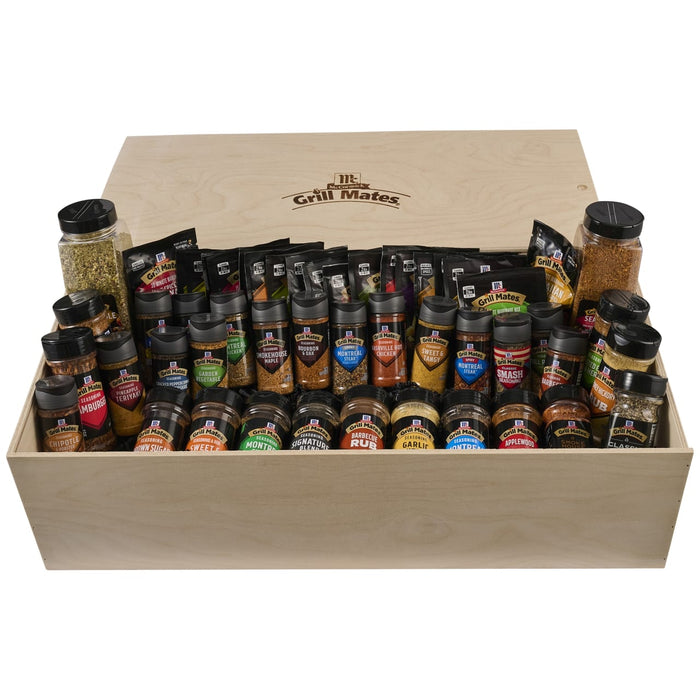 A large wooden crate filled with a comprehensive assortment of McCormick seasonings and marinades belonging to the Dtc Grill Mates Dtcmccgmvp Bundle including varieties like Montreal Steak and Applewood Smoke.
