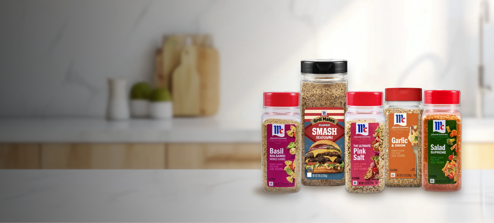 Collection of McCormick seasoning bottles on a kitchen counter with a blurred background.