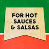 A vintage-style sign with the text For Hot Sauces &amp; Salsas on a yellow background.