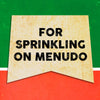 A vintage-style banner with the text FOR SPRINKLING ON MENUDU on a yellow background.