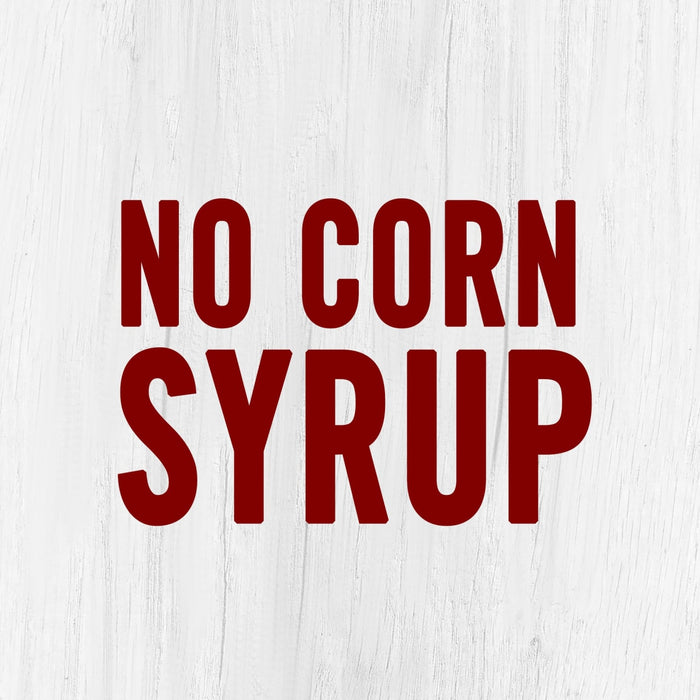 The words No Corn Syrup in red letters on a white wood background.