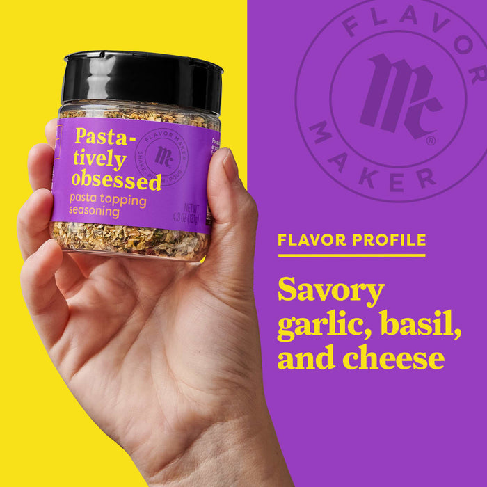 A hand holds a jar of Flavor Maker Pasta-tively Obsessed pasta topping seasoning, with a purple background that says Flavor Profile: Savory garlic, basil, and cheese.
