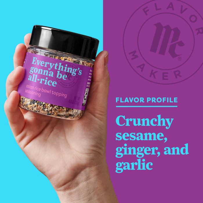 A hand holds a jar of Flavor Maker Everythings Gonna Be All-Rice Asian Rice Bowl Topping seasoning, with the Flavor Maker logo and flavor profile in the background.