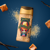 Bottle of Harry Potter Butterbeer sugar with caramel pieces on a blue background