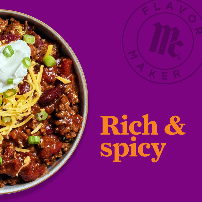 A bowl of chili with sour cream, shredded cheese, and green onions, with the Flavor Maker logo and the text Rich &amp; Spicy in the background.