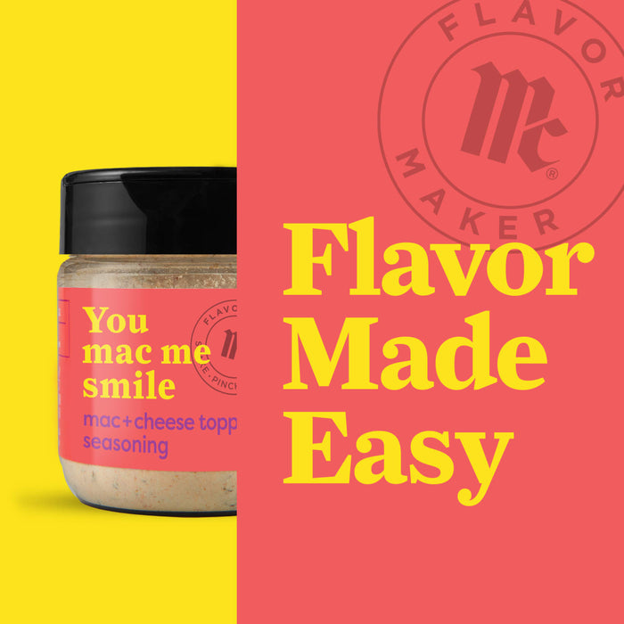 A jar of Flavor Makers You Mac Me Smile mac and cheese seasoning.