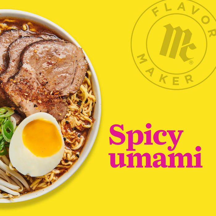 A bowl of ramen with pork, noodles, a soft boiled egg, and green onions with the Flavor Maker logo and the text Spicy umami in the background.