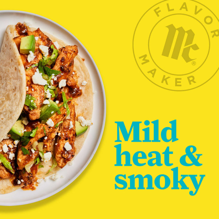 A plate of chicken tacos with avocado, feta cheese, and lettuce with the Flavor Maker logo and the text Mild heat &amp; smoky in the background.