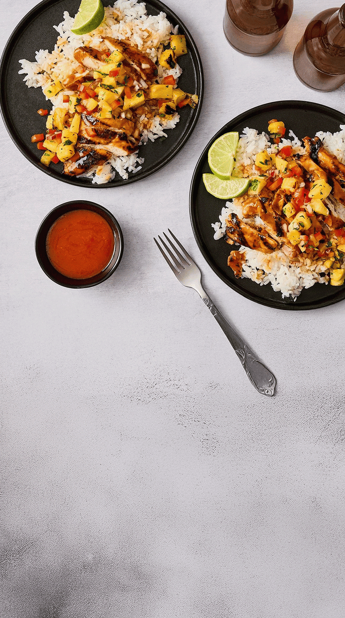 chicken with mango salsa on plates