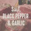 Salt, black pepper, and garlic are sprinkled on top of raw meat.