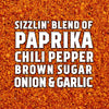 A close-up of a spice blend called sizzlin\ blend of paprika, chili pepper, brown sugar, onion &amp; garlic.
