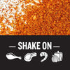 A black background with white text that says Shake On and white silhouettes of a chicken leg steak shrimp and onion and bell pepper