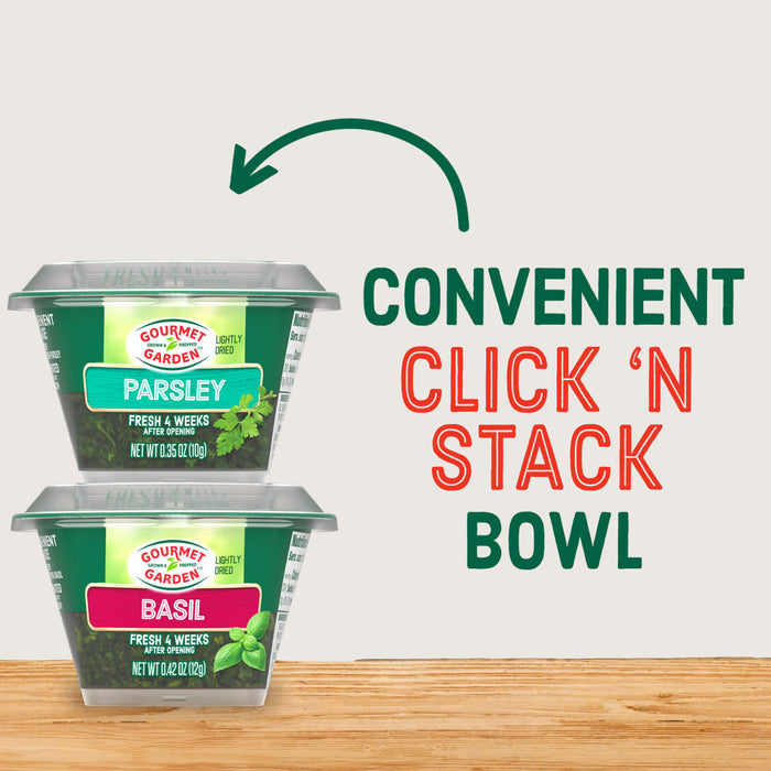 Two containers of Gourmet Garden Chopped Basil, representing the Gourmet Garden Basil (Case Of 72) product, are shown stacked to highlight their convenient 'Click 'N Stack' bowl design, with a green arrow illustrating the stacking action.
