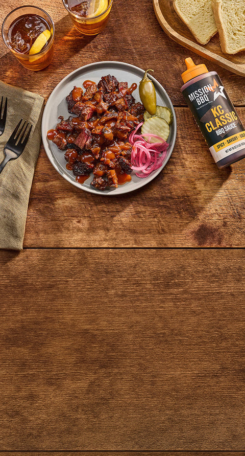 burnt ends on a table with KC classic sauce