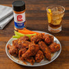 A plate of Lawry's Seasoned Cajun chicken wings with celery sticks and carrots.