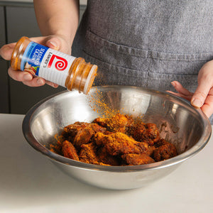Person seasoning chicken wings