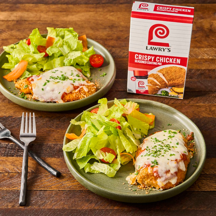 Two plates of Lawrys Crispy Chicken with a side salad.