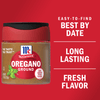 A container of McCormick Oregano Ground with a red lid and a white label with the McCormick logo and the words Long Lasting Fresh Flavor on it.
