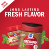 Two McCormick oregano spice jars with a sprig of oregano.