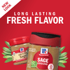 Two McCormick Ground Sage spice jars with sage leaves on a red background.
