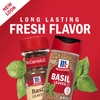 Two McCormick Basil Leaves spice jars with a red background and basil leaves.