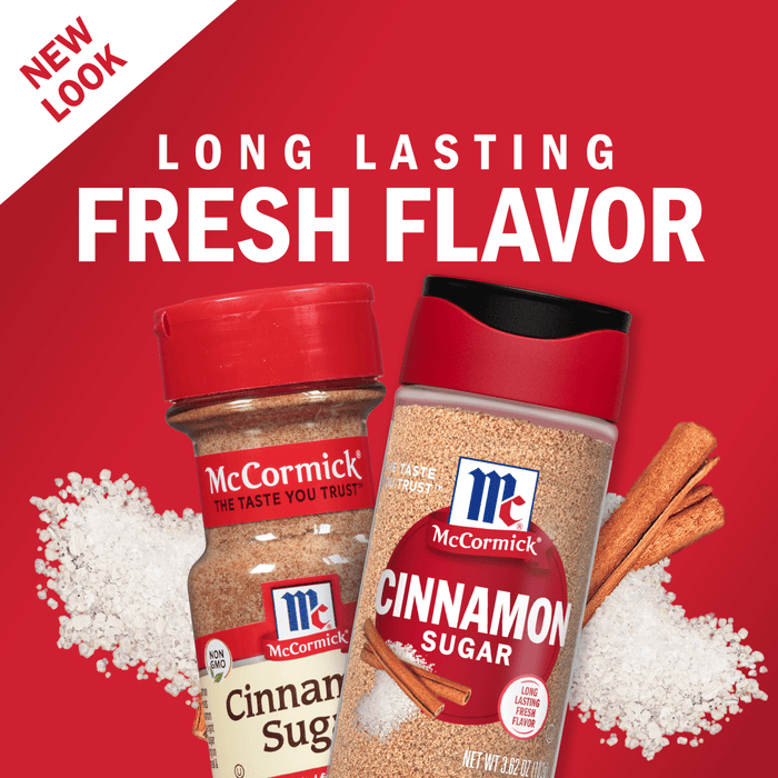 Two containers of McCormick Cinnamon Sugar, one with a red lid and the other with a black lid, are shown on a red background with white sugar crystals and cinnamon sticks.